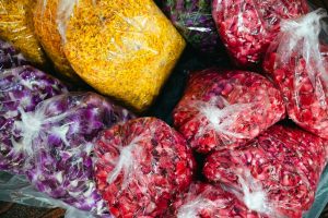 a bunch of bags filled with different types of vegetables
